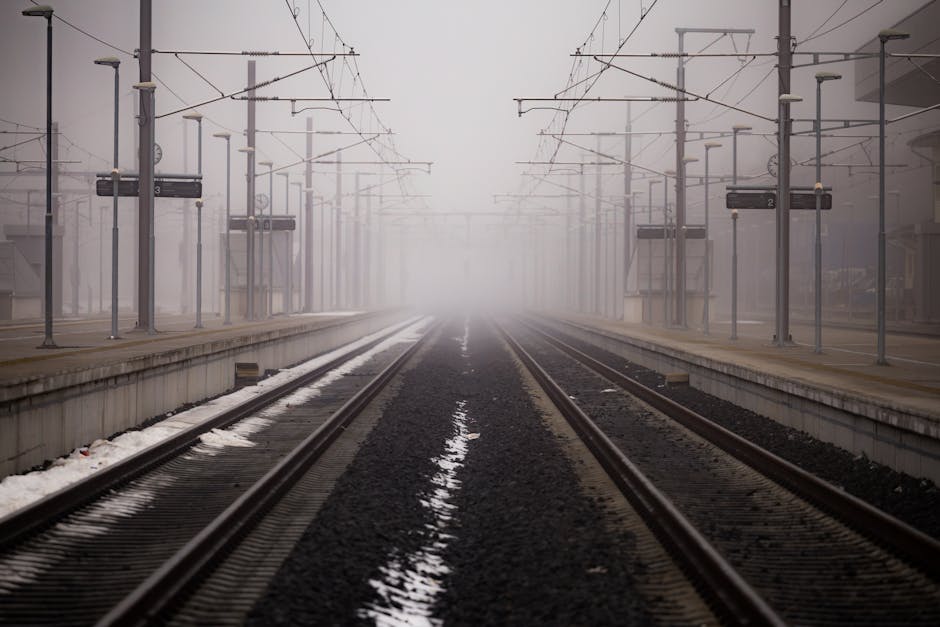 pexels-photo-210782-210782 Misty railway platform enveloped in fog at a winter station.
